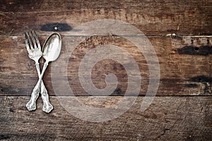 Antique Silverware over Wooden Background