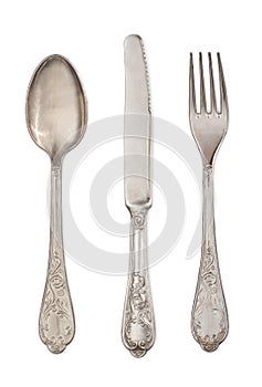 Antique silverware: spoon, knife and fork isolated on a white background