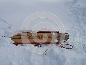 Antique sled stuck in snow