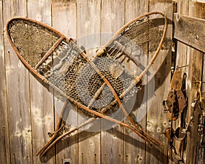 Antique Snow Shoes Hanging on Wooden Wall