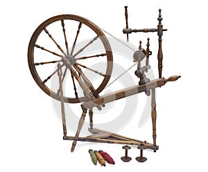 Antique spinning wheel with yarn and bobbins isolated on white