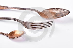 Antique spoons and fork, white background.
