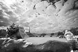 Antique statue on bridge Alexandre III, the river Seine and the Eiffel tower, Paris France, black and white photography