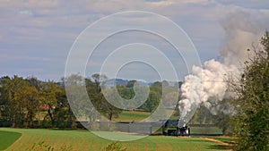 Antique Steam Passenger Train Traveling Thru Trees and Farmlands