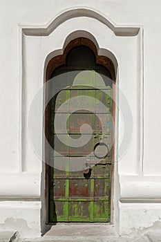 Antique steel door with padlock close-up