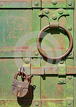 Antique steel door with padlock close-up