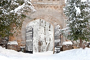 Antique stone gates of royal palace in Sigulda covered with winter snow