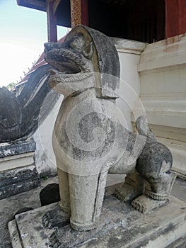 Antique stone lion guarding the temple entrance