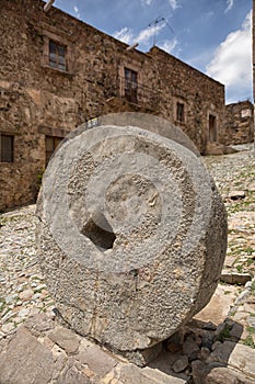 Antique stone mill wheel on the street