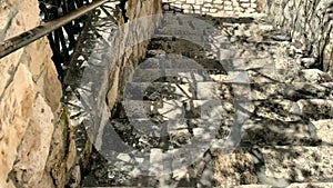 Antique stone staircase with metal railings