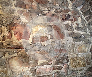 Antique stone wall masonry on a city street