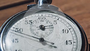 An Antique Stopwatch Lies on Wooden Table and Counts the Seconds, Timelapse