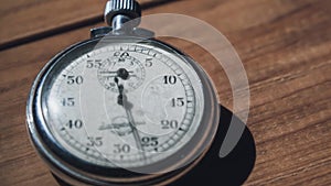 An Antique Stopwatch Lies on Wooden Table and Counts the Seconds, Timelapse