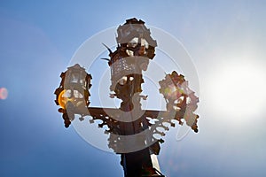 Antique street lamp and blue sky on background. Large street lamp with five lamps