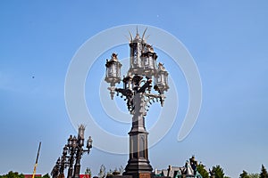 Antique street lamp and blue sky on background. Large street lamp with five lamps