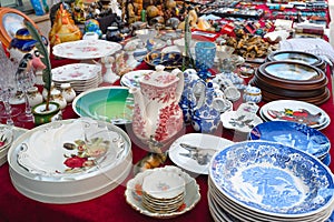 Antique stuff for sale in a flea market. Antiquities, vintage dishes