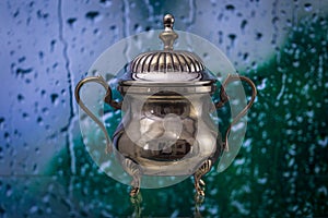 Antique Sugar Bowl Silverware Reflection Bokeh Rainy Window Background