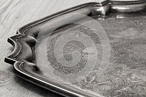 Antique tarnished silver tray with engraved pattern