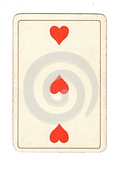 An antique three of hearts playing card.