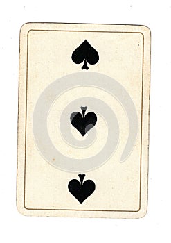 An antique three of spades playing card.