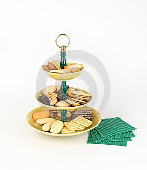 Antique Three Tier Server Tray with an Assortment of Cookies and Napkins.