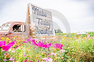 Antique tractor trailer photography prop on a flower farm field next to wild flowers, with the quote `make today beautiful`