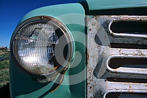 Antique truck grille and broken headlight