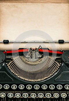 Antique typewriter with aged textured paper sheet