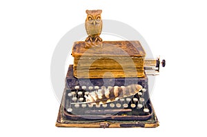 Antique typewriter with owl and old book isolated on white