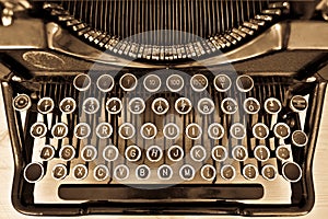 Antique typewriter on sepia