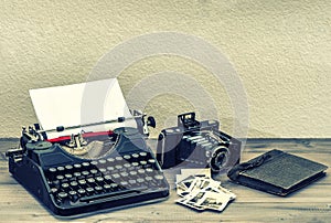 Antique typewriter and vintage photo camera