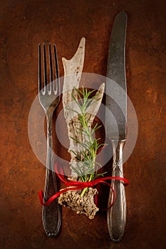 Antique, vintage cutlery with rosemary and deer antler decorated on a table