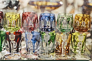 Antique vintage multicolored crystal glasses, retro style background