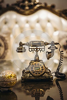 Antique Vintage rotary old hang up telephone model with Beautifully embossed gold bronze texture in retro style. Old