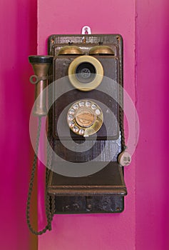 Antique vintage telephone purple grunge background.