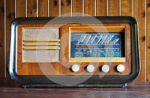 Antique vintage wooden radio with glass panel on wood wall background