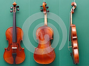 Antique violin from all sides on green background