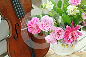 Antique violin, notes and spring bouquet