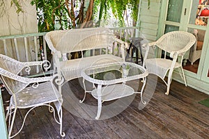 Antique weaving chairs with table on wood patio