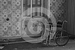 Antique wheelchair in abandoned house