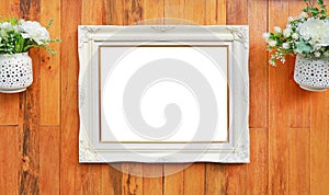 Antique white photo frame with empty space for your picture or text placed on wood plank wall background