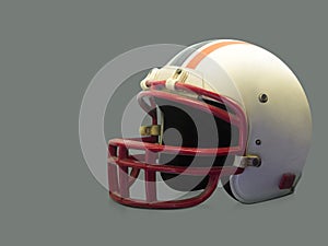 Antique white and red American football helmet on gray background, object, copy space