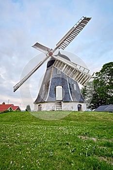 Antique windmill next to house in the city
