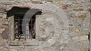Antique window in stone wall