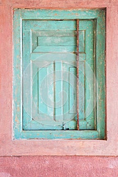 Antique window shutters closed green.