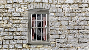 Antique window in stone wall