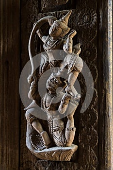 Antique wood carving in the form of deities