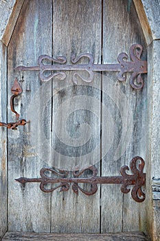 Antique wood front doors with wrought iron hinges