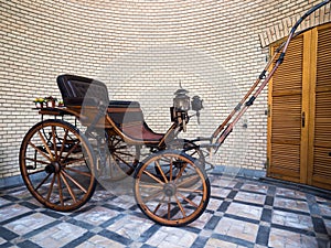 Antique wooden buggy with oil lantern.