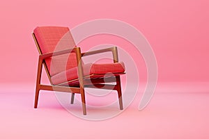 an old chair in pink, with a wood frame and cushion on top